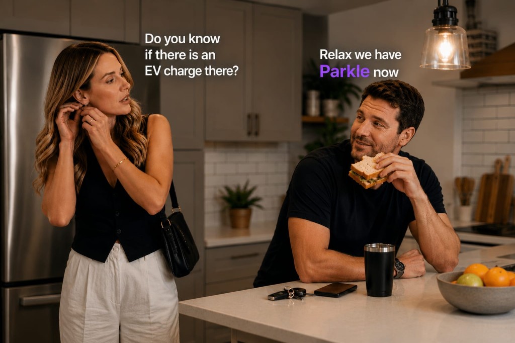 A couple in the kitchen, she asks if there is EV charging at their destination and he reassures her that they have Parkle